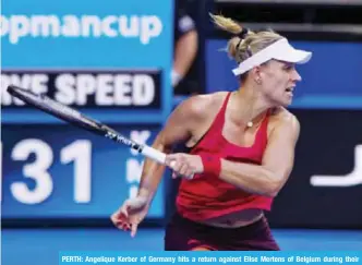  ??  ?? PERTH: Angelique Kerber of Germany hits a return against Elise Mertens of Belgium during their women’s singles match on day three of the Hopman Cup tennis tournament in Perth yesterday. — AFP