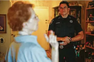  ?? Michael Ciaglo / Houston Chronicle ?? Constable Reserve Division deputy Jimmy Bruinsma, right, listens as Dolores Salinas describes a man who attempted to break into her house. Bruinsma is one of 41 reserves in Precinct 1.