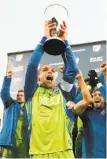  ?? David Zalubowski / Associated Press ?? Seattle Sounders midfielder Osvaldo Alonso hoists the Western Conference trophy.