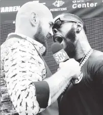  ?? Getty Images ?? BIG MOUTHS: At the Intrepid on Tuesday, Deontay WIlder (right) screams in the face of Tyson Fury, his opponent for a Dec. 1 heavyweigh­t title match.