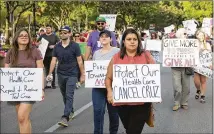  ?? JAY JANNER / AMERICAN-STATESMAN ?? Dozens of people march outside the Renaissanc­e Austin Hotel last month to protest Sen. Ted Cruz’s stand on health care reform. Cruz was speaking at the hotel.