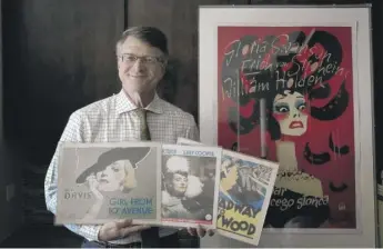  ?? CHARLES REX ARBOGAST/AP ?? Dwight Cleveland with several lobby cards in front of a Polish movie poster for the 1950 film “Sunset Blvd.” Cleveland once owned an archive of 45,000 movie posters from 56 countries.