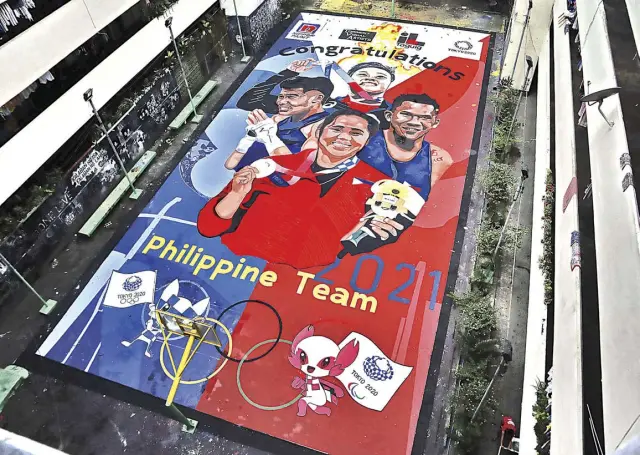  ?? ROY DOMINGO ?? THE Tenement in Western Bicutan in Taguig City, known for its tribute murals painted on its central courtyard that was turned into a basketball court, pays tribute to Tokyo 2020 Olympics medalists Hidilyn Diaz, Nesthy Petecio, Eumir Marcial and Carlo Paalam. Among its most notable tributes earlier were Lebron James, who visited the place in 2016, and Kobe and Gianna Bryant, who died in 2020.