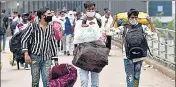  ?? ANI ?? Migrant workers arrive at Anand Vihar Bus Terminal to leave for their hometown in New Delhi on Tuesday.