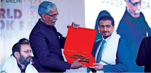  ??  ?? Ahmed Al Ameri receives a memento during the opening ceremony of the New Delhi World Book Fair.