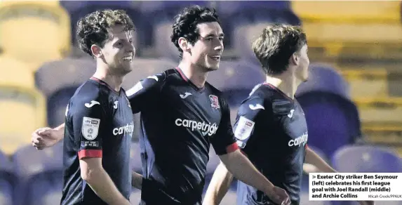  ?? Micah Crook/PPAUK ?? > Exeter City striker Ben Seymour (left) celebrates his first league goal with Joel Randall (middle) and Archie Collins
