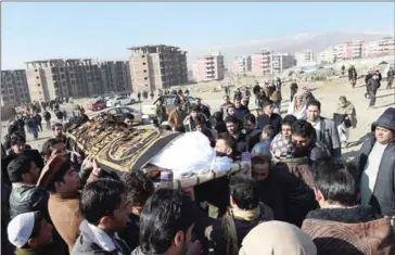  ?? AFP ?? Afghan mourners carry the coffin of one of the 36 victims killed in twin Taliban blasts, in Kabul yesterday.