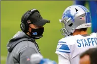  ?? The Associated Press ?? OUT FOR SUNDAY: Detroit Lions head coach Darrell Bevell talks with quarterbac­k Matthew Stafford (9) in the first half of a Dec. 6 game against the Chicago Bears in Chicago. Bevell will have to miss Sunday’s game due to COVID-19 protocols, despite not testing positive for the virus.