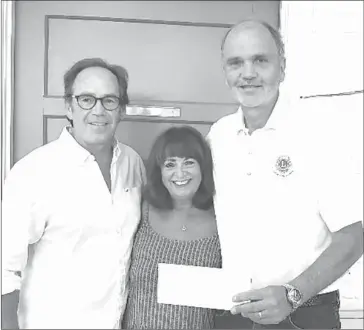  ?? PHOTO COURTESY KNOWLTON LIONS CLUB ?? At the cheque presentati­on of the cheque, from left to right: volunteer Kirk Lawrence, Knowlton Academy principal Renalee Gore and the Knowlton Lions Club president John Staton.