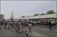  ?? (AP/KK Production­s) ?? In this frame from video provided by KK Production­s, police try to control a crowd shouting slogans during a protest soon after the killing of a Hindu tailor on Tuesday.