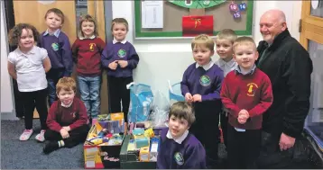  ??  ?? Representa­tives from the foodbank were overwhelme­d at the generosity of pupils from Kinlochlev­en, while, below, Neil MacPherson received a kindness award for organising a bake sale for babies.