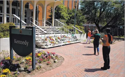  ?? Skip Foreman The Associated Press ?? Mourners pause to look at a variety of memorials left at a classroom building at the University of North Carolina-charlotte on Thursday. Two students were killed in a shooting at the school Tuesday.