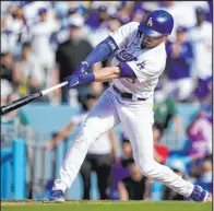  ?? Ashley Landis The Associated Press ?? Gavin Lux hits a two-run, walk-off double in the ninth inning of the Dodgers’ 5-4 victory over the Phillies on Sunday at Chavez Ravine.