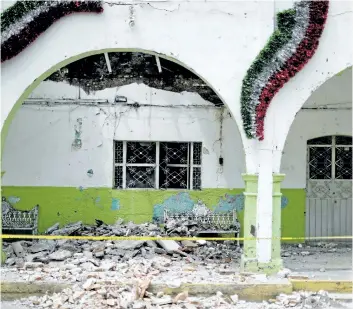  ?? NATACHA PISARENKO/AP PHOTO ?? The collapsed town hall of Tepeojuma is seen after an earthquake in Mexico, on Sunday. As the search continued Sunday for survivors and the bodies of people who died in quake-collapsed buildings, specialist­s have fanned out to inspect buildings and...