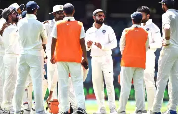  ??  ?? India’s captain Virat Kohli (centre) talks to teammates during day five of the first Test cricket match between Australia and India at the Adelaide Oval in this file photo. — AFP photo