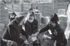  ?? TODD HEISLER The New York Times ?? People at a food pantry in Brooklyn just prior to Thanksgivi­ng. The president’s demand that Congress amend a giant pork-laden coronaviru­s relief and government spending bill has raised the unexpected prospect that help may no longer be days away.