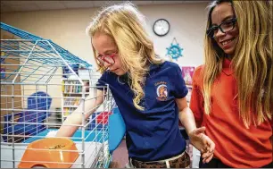  ?? YFFY YOSSIFOR/FORT WORTH STAR-TELEGRAM ?? Riley Robinson, 8, with her sister, Jada, 10, is back at school at Calvary Christian Academy after missing most of last year while waiting for a lifesaving heart transplant.