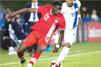  ??  ?? Alphonso Davies (left) in action