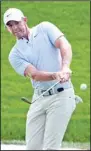  ?? ?? Rory McIlroy, of Northern Ireland, chips onto the third green during the second round of The Players Championsh­ip golf tournament in Ponte Vedra Beach, Fla. (AP)