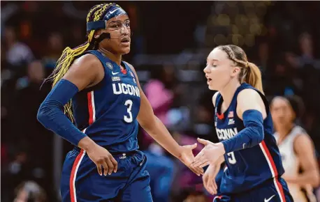  ?? Gregory Shamus/Getty Images ?? UConn’s Aaliyah Edwards (3) and Paige Bueckers (5) react during Friday’s Final Four game in Cleveland against Iowa.