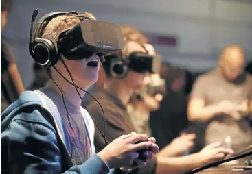  ?? Picture: MATTHEW LLOYD/BLOOMBERG VIA GETTY IMAGES ?? NEXT STEP IN GAMING? Players wear virtual-reality headsets made by Oculus during the Eurogamer Expo 2013 in London. This week, Facebook announced that it had concluded a deal to buy Oculus