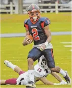  ??  ?? LOOKING FOR MORE: Milton Academy’s Jailen Branch peers downfield after avoiding the reach of Belmont Hill’s Joshua Wax.