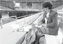  ?? AP PHOTO ?? Precinct captain Barbara Hatinger works on paperwork Tuesday before the doors are opened for the Black Hawk County Republican caucuses site at the UNI-DOME in Cedar Falls, Iowa.