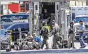  ?? JOHN SPINK / JSPINK@AJC.COM ?? Authoritie­s with a bomb squad robot gather at the scene of Tuesday’s self-immolation by a man identified as Air Force veteran John Michael Watts outside the state Capitol in downtown Atlanta.