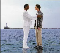  ?? RALPH NELSON/ILLUSION ARTS ?? Bruce Nolan (Jim Carrey, right) gets a lesson from the Almighty (Freeman) in ‘Bruce Almighty.’