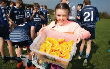  ??  ?? Clodagh O’Toole hands out the orange slices to the Michael Dwyers players.