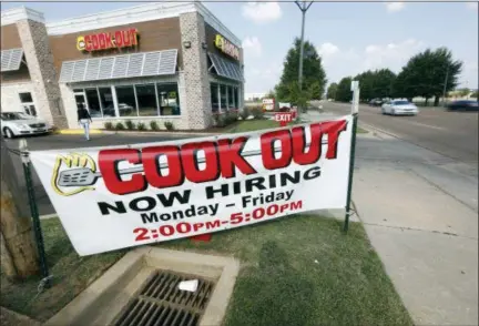  ?? ROGELIO V. SOLIS — THE ASSOCIATED PRESS ?? Cars drive by a help wanted sign at a Cook Out fast food restaurant in Jackson, Miss. On Thursday, Sept. 6, payroll processor ADP reported how many jobs private employers added in August.