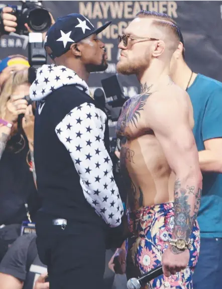  ?? Picture: AP PHOTO ?? Conor McGregor (right) faces off with Floyd Mayweather ahead of their looming superfight.