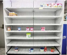  ?? Getty Images/tns ?? Shelves normally meant for baby formula sit nearly empty at a store in downtown Washington, D.C., on May 22.