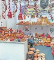  ??  ?? A craftsman at his store