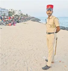  ?? ?? Photograph shows a policeman wearing a French Kepi hat standing guard at a beach in Puducherry.