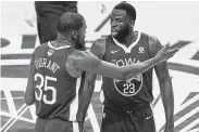  ?? Lachlan Cunningham / Getty Images ?? Warriors teammates Kevin Durant, left, and Draymond Green don’t always see eye to eye.
