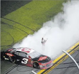  ?? Phelan M. Ebenhack ?? The Associated Press Austin Dillon acknowledg­es the cheers of the crowd after performing a burnout following his overtime victory in the Daytona 500 on Sunday.