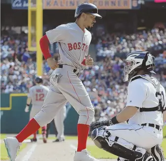  ?? AP PHOTO ?? ON THE PLATE: Mookie Betts, who returned to the lineup yesterday after battling the flu, scores a run during yesterday’s win in Detroit.