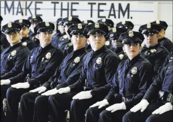  ?? BRENNAN LINSLEY/THE ASSOCIATED PRESS FILE ?? Police cadets attend a graduation ceremony at the Denver Police Training Academy in 2014. Denver is one of several cities nationwide that have approved measures to create or strengthen civilian oversight of local law enforcemen­t.