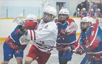  ?? BOB TYMCZYSZYN THE ST. CATHARINES STANDARD ?? Former Welland General Adam Kirchmayer, foreground, now with the St. Catharines Spartans, faces his former team in junior B lacrosse Friday night at Merritton Arena in St. Catharines.