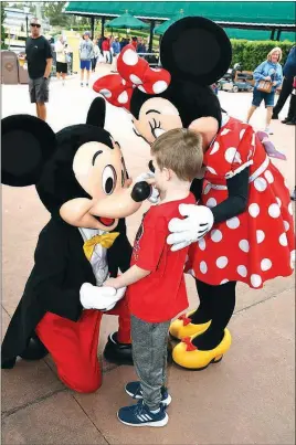  ?? SUBMITTED ?? Jackson Barnes, 6, of Cabot, feels Mickey’s nose during a Make-A-Wish Foundation trip to Disney World and Sea World in Orlando, Fla., earlier this month. Jackson is losing his eyesight because of Batten disease, a fatal genetic disorder of the nervous system.