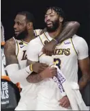  ?? AP file photo ?? LeBron James and Anthony Davis celebrate the Los Angeles Lakers’ NBA championsh­ip title in October. The Lakers begin the season Dec. 22 — the NBA’s opening night — against the Los Angeles Clippers.