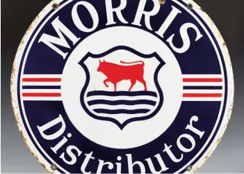  ?? ?? A ‘Morris Distributo­r’ double-sided enamelled circular advertisin­g sign, finished in blue, white and red, diameter 72.5cm