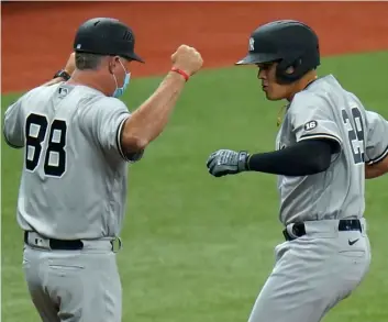  ?? AP Photo/Chris O’Meara ?? New York Yankees’ Gio Urshela (right) celebrates his two-run home run off Tampa Bay Rays starting pitcher Michael Wacha with third base coach Phil Nevin during the third inning of a baseball game on Sunday in St. Petersburg, Fla.