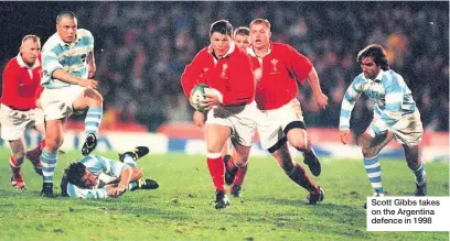  ??  ?? Scott Gibbs takes on the Argentina defence in 1998