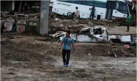  ?? (Jaime Saldarriag­a/Reuters) ?? A MAN WALKS among the ruins yesterday after flooding and mudslides caused by heavy rains led several rivers to overflow in Mocoa, Columbia.