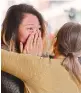  ??  ?? A woman cries in front of the reopened department store that was attacked