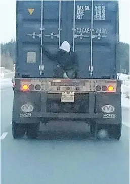  ?? EMILE CLAVEAU, VIA THE CANADIAN PRESS ?? As Emile Clave drove to work along a busy highway in Quebec’s Saguenay-LacSaint-Jean region, he noticed a man perched on the back of a transport truck.