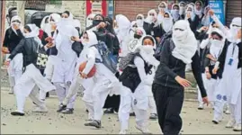  ?? PTI ?? Kashmiri students hurling stones at security personnel during clashes in Srinagar on Monday.