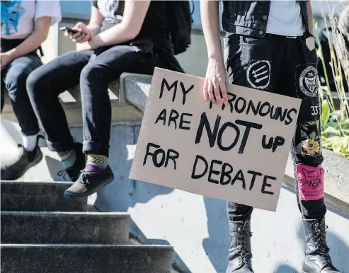  ?? TYLER ANDERSON / NATIONAL POST FILES ?? A student holds a sign at a 2016 protest at the University of Toronto against professor Jordan Peterson, who had refused to refer to transgende­r people by their chosen pronouns.
